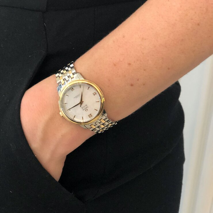montre Omega avec un boîtier en or jaune sur acier, un cadran nacre et un diamètre de 32.7 mm